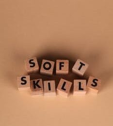 Wooden blocks arranged to spell 'Soft Skills' on a brown background